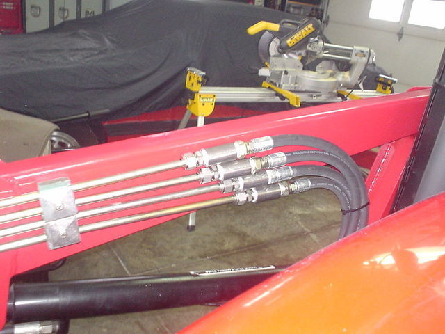 Loader Hydraulic hoses joined to hard piping on loader frame with Swagelok 12mm compression fittings.JPG